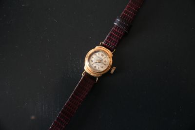 an image of a wrist watch on a black surface