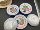 four plates and a bowl sitting on a counter