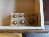 a small wooden box with buttons in it on a table