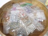 a wooden bowl filled with lots of beads on a table