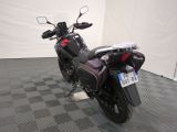 a motorcycle that is parked in a room with a checkered floor