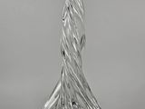 a clear glass vase sitting on top of a table next to a white wall