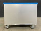 a white and blue cart sitting on top of a cement floor