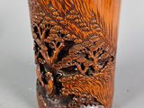a wooden cup that has a picture of a tree on it
