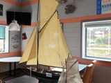a model sailboat sitting on a table in a room