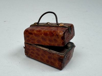 two pieces of luggage sitting on top of each other