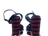 pair of red and black sandals with pearls on the toes