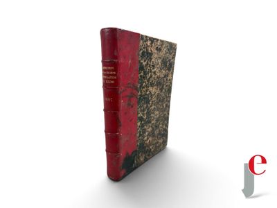 an old book with a red cover sitting on top of a white surface
