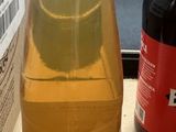 a bottle of liquid sitting on a table next to a bottle of beer