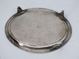 a silver plate on a white table with a white background