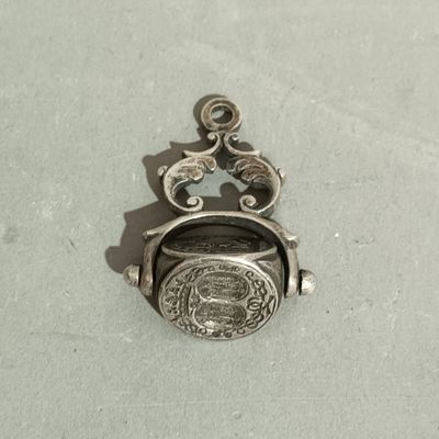 a silver locke with a picture on it on a table