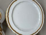 a white and gold tea set with a gold rim