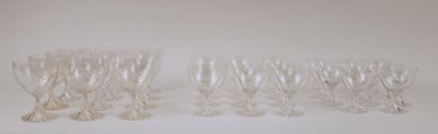 six clear wine glasses sitting on top of a white table