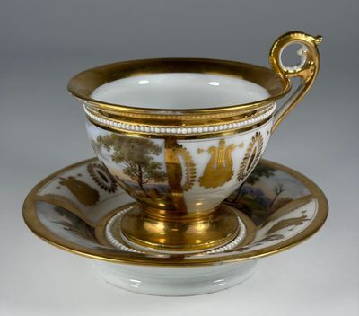 an image of a cup and saucer with a gold rim