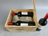 three bottles of wine in a wooden box