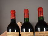 three bottles of wine sitting on top of a wooden crate