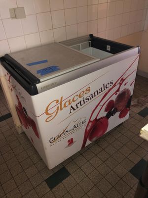 an ice cream machine sitting on the floor in the kitchen