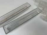 three pieces of plastic on a white table