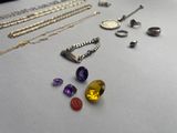 many different types of necklaces and rings on the table