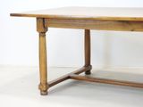 a wooden table with a wooden top on a white floor