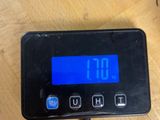 a digital scale on a table with a clock on it