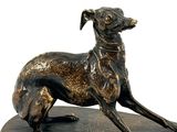 bronze statue of a dog sitting on top of a tortoise