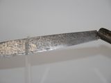 a large knife that is on display on a table