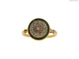 a close up of a gold ring with a coin on it