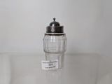a salt shaker sitting on a table with a price tag