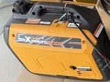 yellow and black portable generator sitting on top of a cardboard box