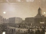 a lot of people that are standing in front of a building