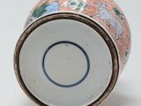 a close up of a vase on a white surface