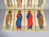 six religious paintings of saints in different colors on a table