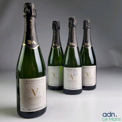 four bottles of wine are lined up on a table