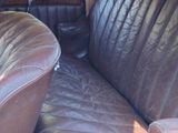 an old car with leather seats in the back of it