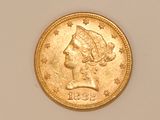 a close up of a gold coin with a woman ' s head on it