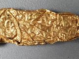 a gold object that is laying on a table