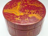 a red box with a painting on it sitting on a table