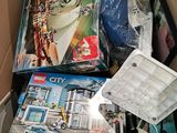 a box full of legos and other toys in it