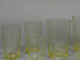 five glasses sitting next to each other on a table