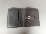 someone is holding a wallet that has a lock on it