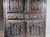 an old wooden cabinet with carvings on the doors and drawers