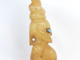 a figurine of a man with a bird on his head