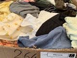 a box full of clothes that are on the floor