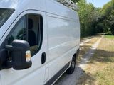 the white van is parked on the side of the road