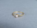 a gold ring with a pearl on top of it
