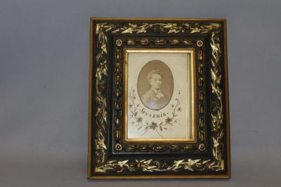 an old picture of a man in a black and gold frame
