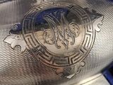 a silver vase with a monogram on it