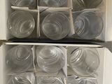 many empty glass jars in a box on the floor