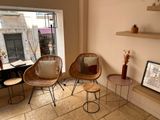 two wicker chairs and a table in a living room
